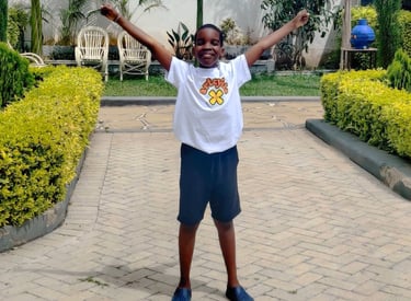 Little boy with arms in the air and smiling