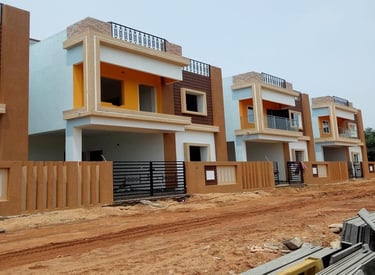 a row of three story houses with a fenced in area by DARSANS Infraa