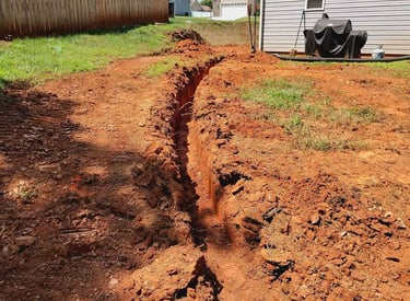 Buried gutter downspout extension connected to underground drainage pipe in Hickory NC to protect ho