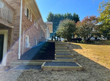 Timber landscape steps installed beside home in Newton NC to manage yard slope