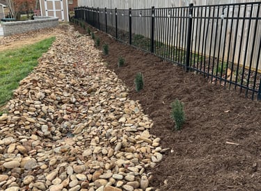 Dry creek bed drainage system installation in Newton NC to control runoff and reduce erosion along p