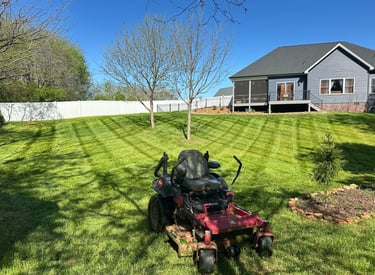 Zero turn lawn mowing service in Newton NC creating striped residential lawn