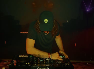 a man in a hat and a hat on a dj booth