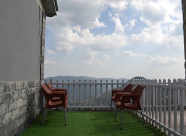 Balcony view from Sunset Heights, offering top-rated apartments for rent in Murree