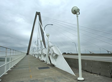 a bridge with a white bridge and a street light