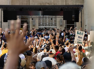 Group of people with hands raised during Houston Jesus March