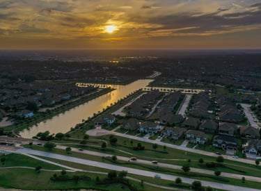 A sunset image of a man made lake in the form of a cross near Towne Lake Memorial Park, Cypress, TX