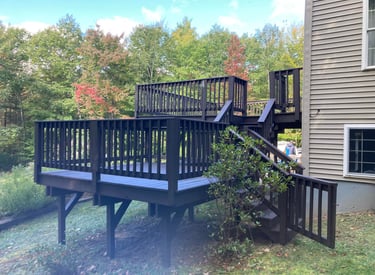 a wooden deck with a wooden deck and stairs