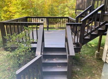 a wooden deck with a staircase leading to a deck