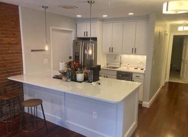 a kitchen with a refrigerator, stove, and counter top