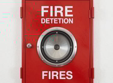 Electrical engineers collaborating over building blueprints in a modern office.