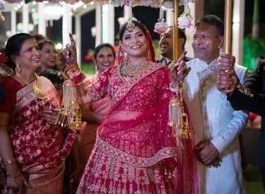 Bride in red lehenga at her wedding.