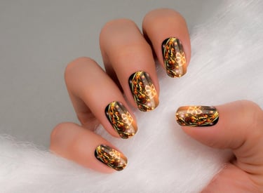 a woman's hand painted nails with gold foil and glitter
