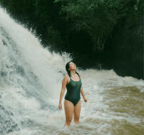 woman under waterfall at wellness retreat in Chiapas