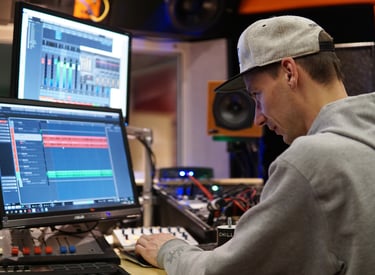 a man professionally masters music in a studio on a computer