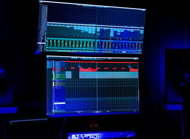 two monitor screens to mix and produce gs in a studio, speakers are left and right