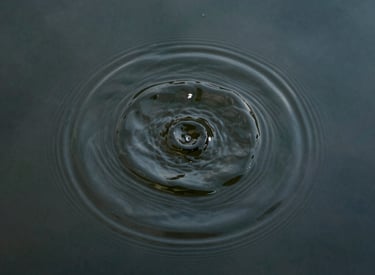 Stack of books on a wooden table with warm natural light.