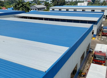 A panoramic view of a completed industrial roofing project at dusk.