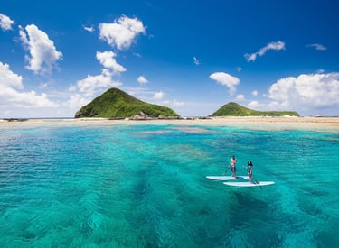 surfing in okinawa- picture of a couple surfing outside of okinawa island