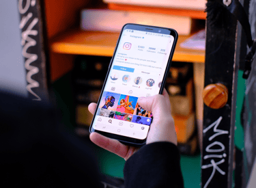 a person holding a cell phone in their hand seeing social media