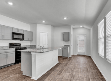 a kitchen with a stove top oven and a microwave