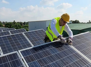 Professional technician installing solar panels on a rooftop for renewable energy efficiency.