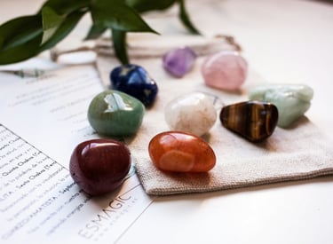 a group of coloured stones sitting on top of a piece of paper