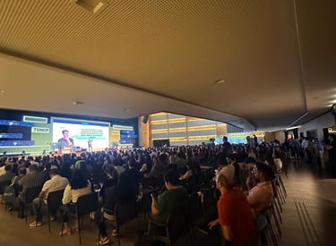 a large group of people sitting in chairs in a room