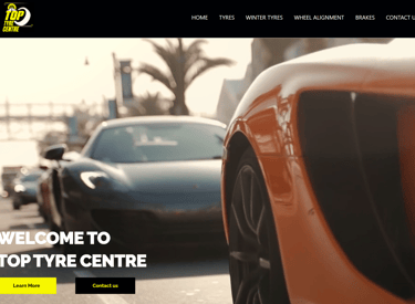 a car with a large screen displaying a photo Top Tyre Centre Website