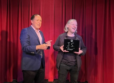 Bay Area mentalist David Martinez makes an on-stage helper laugh during a mentalist experience
