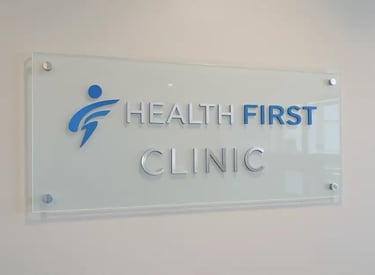 Acrylic clinic reception signboard with HEALTH FIRST CLINIC logo – SignageBoard.ae