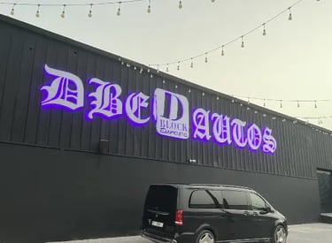 dbe autos dubai 3d acrylic backlite signage mounted on corrugated metal wall