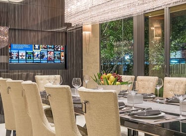 Large TV hidden behind a motorised wall panel with screen advance forward