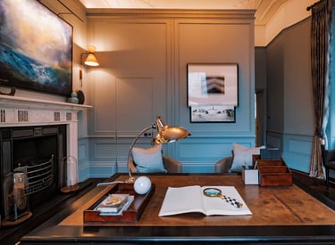TV hidden behind a moving wall panel with artwork