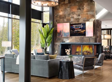 TV hidden behind a split moving panel with artwork