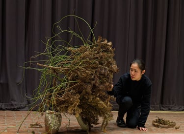 Hedy Leung’s Ikebana performance Ethnobotanic Resonance, with dried plants at The Wash Houses London
