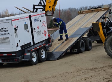 A trip trailer being loaded with a generator