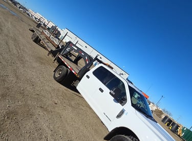 A truck with a gooseneck trailer getting ready for its next hotshot trip