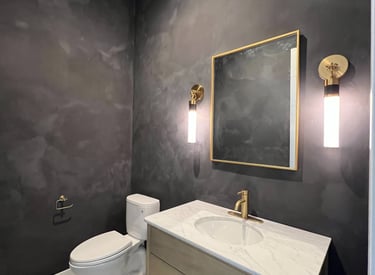 A bold and dramatic black limewash finish enhances the elegance of this luxury bathroom in Phoenix.