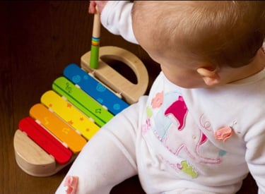 Infant playing with musical instrument 