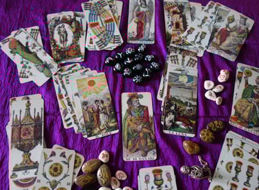 tarot cards and runes on a purple reading cloth