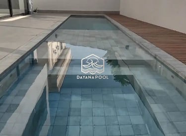 Desain kolam renang minimalis modern dengan air jernih di halaman belakang rumah