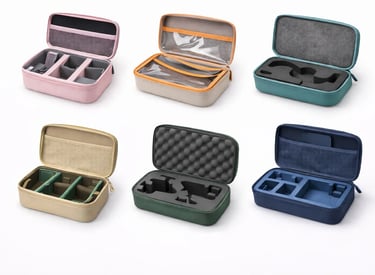 Assorted portable hard shell travel organizer cases with customizable foam and mesh pockets in various colors.