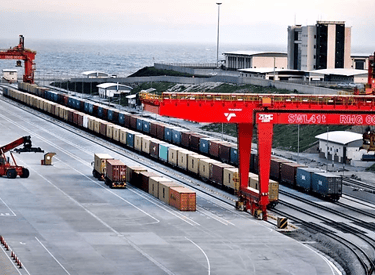 a train on a train track with a crane