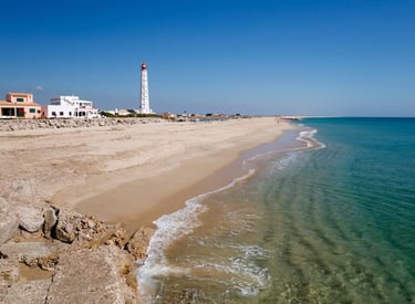 a lighthouse tower in the distance with a lighthouse in the foreground