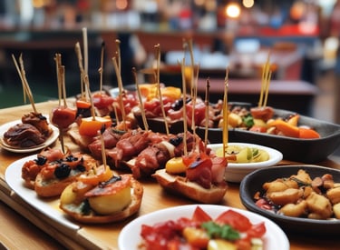 Three gourmet burgers are arranged on a wooden board. The buns are sprinkled with sesame seeds and have skewers topped with grilled meat and a pickled onion. The burgers are filled with beef patties, fresh arugula, tomato slices, and a dollop of creamy cheese.