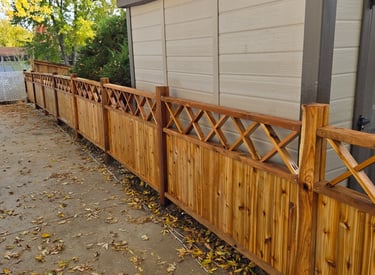 Custom cedar fence with cross-hatched top, design built and installed by Isaac Griffin