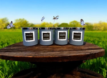 Four luxurious aromatherapy essential oil candles with a natural background