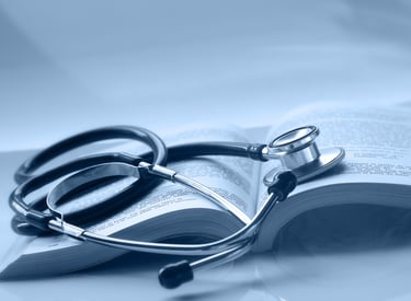 An open medical book with a stethoscope on top of it