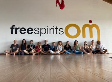 a group of yogis sitting on a wooden floor